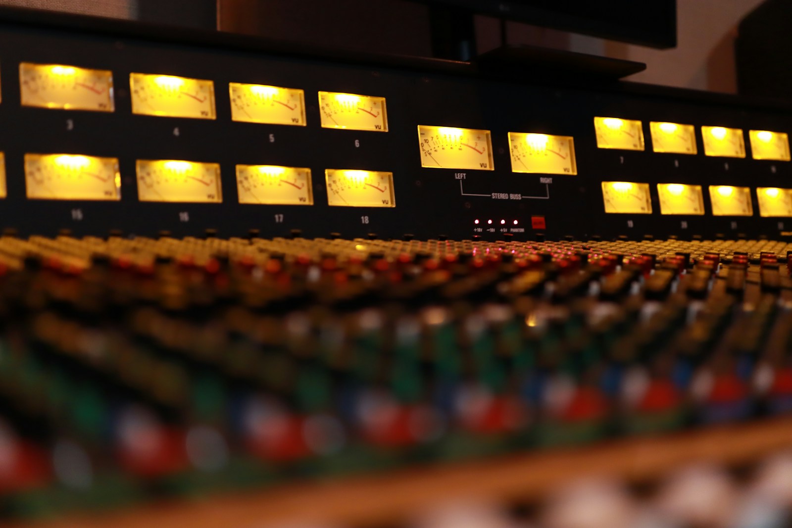 Illuminated meters on an analog recording console at Old Fashion Studios, Los Angeles. Illustrative stock photograph.